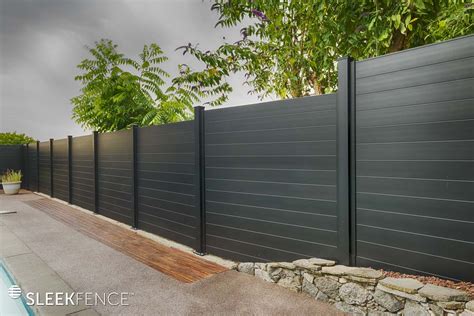 The gate includes a modern-looking black metal frame. . Black metal privacy fence